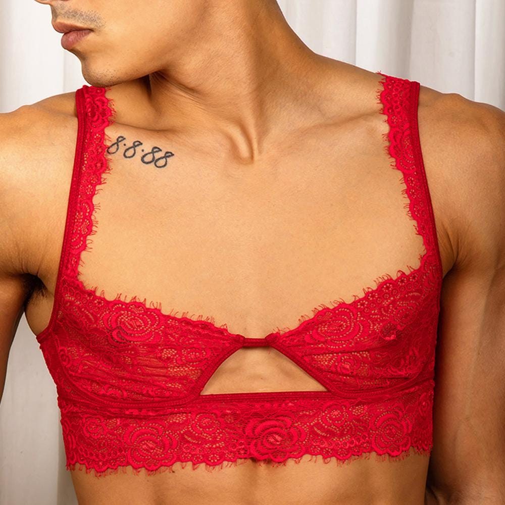 Secret Male Low Cut Bra in red floral lace, low scooped neckline, wide lace straps and a knotted center with a keyhole cutout, worn on a man's chest