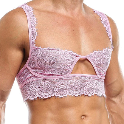 A person in the Secret Male Low Cut Bra by Secret Male displays intimate mens fashion. The pink lace bralette boasts delicate floral patterns, a cutout design, thin lacy straps, and intricate edge detailing, elegantly highlighting seductive menswear from shoulder to waist.