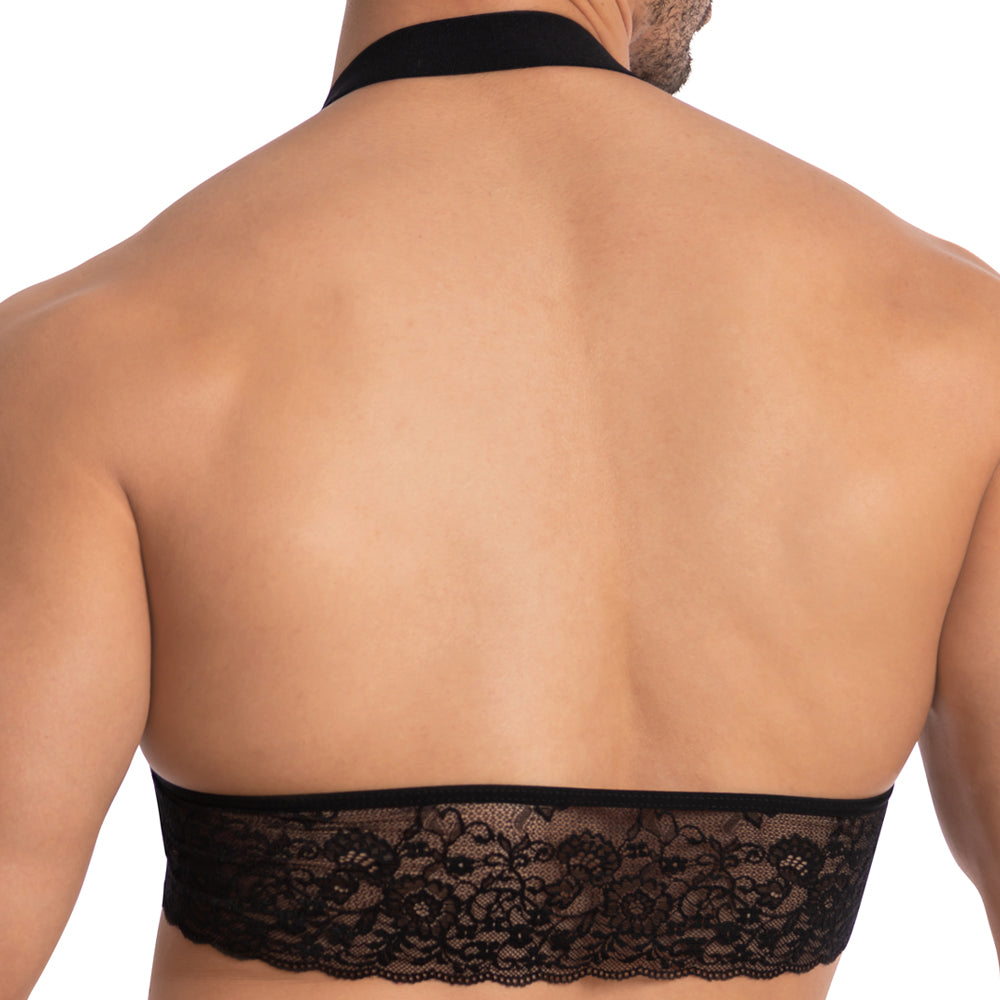 A person is seen from behind wearing the Secret Male SMA021 Gorgeous George Top, which features a wide band of intricate lace across the back and a thick neck strap, leaving their shoulders and upper back exposed.