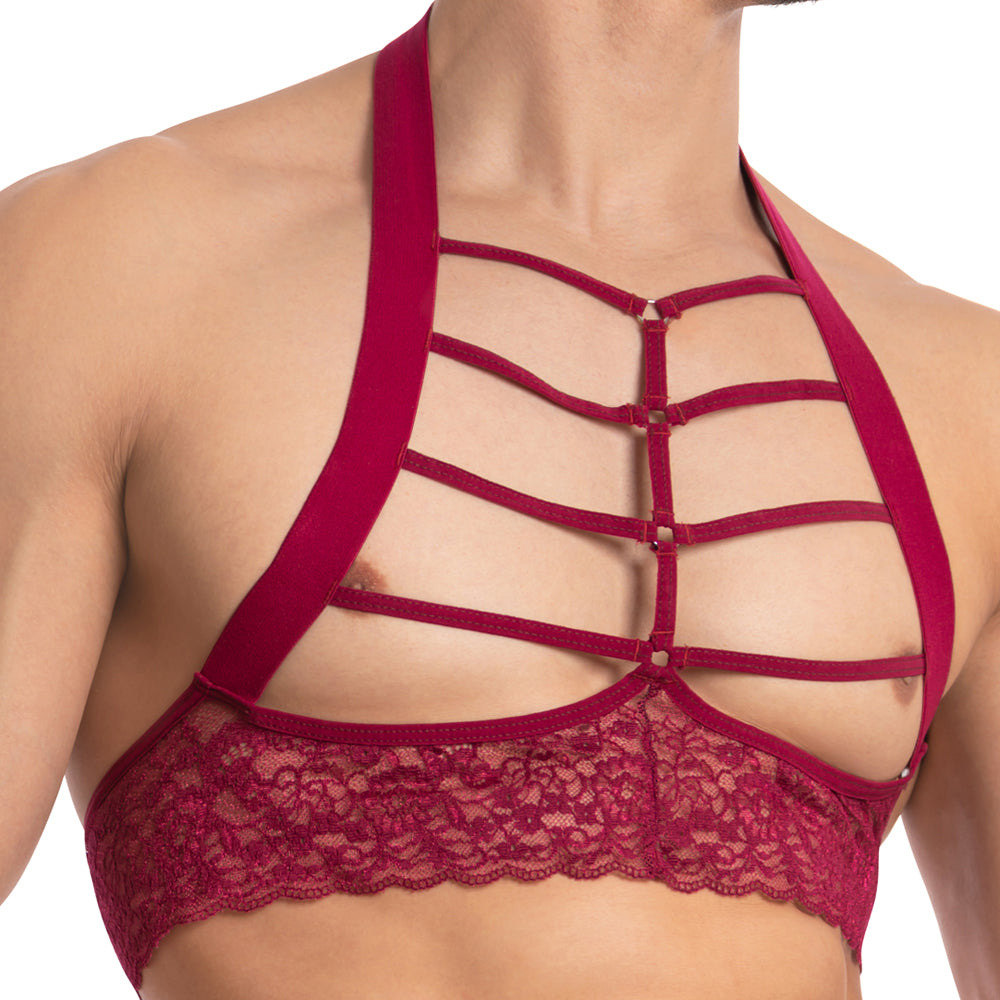 A person is wearing the Secret Male SMA021 Gorgeous George Top, a stylish red lace top featuring multiple horizontal straps across the chest for a sexy, form-fitting mens look.
