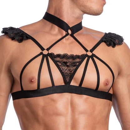 Wearing Secret Males Seductive Floral Top, with sheer fabric, lace details, and shoulder ruffles; the geometric-patterned harness with a choker neckpiece beautifully contrasts against tan skin, highlighting its intricate design.