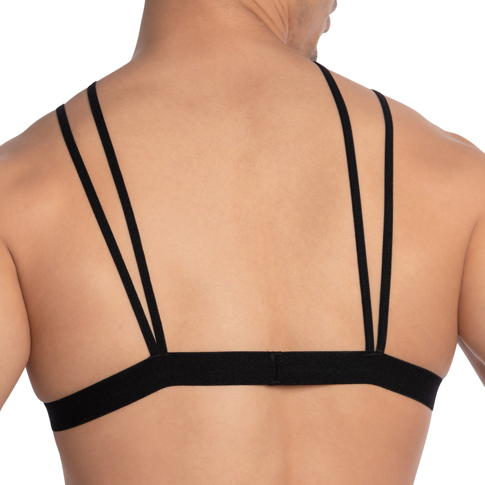Someone is wearing a Secret Male Floral See Through Top, revealing a black strappy bra with three visible thin straps on their back, highlighting the design and customizable fit.