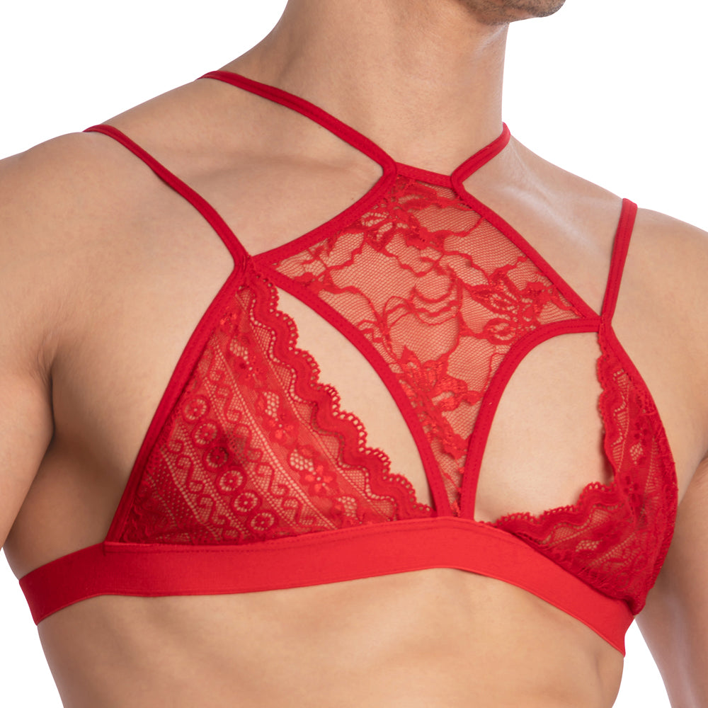 A person is wearing the Secret Male Floral See Through Top, a bold and fashion-forward choice from the Secret Male brand, featuring a red lace bralette with intricate floral patterns, multiple thin straps for a customizable fit, and coverage akin to a decorative tank top.