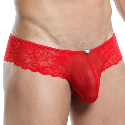 A person wearing Secret Male Bikini underwear in red lace with a floral pattern, highlighted by a decorative center element. The sleek design stands out against the plain light background, enhancing the confidence-boosting ensemble from Secret Male.