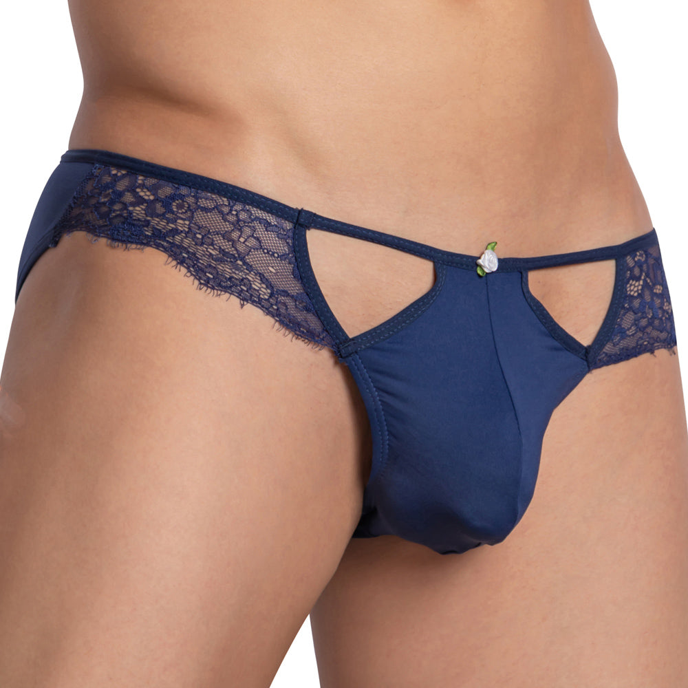 A person models the Secret Male Mesh Lace Bikini, crafted by Secret Male. This navy blue lingerie features a lace design with cut-out details, a C-shape pouch, and a small decorative flower at the front, standing out elegantly against the plain white background.