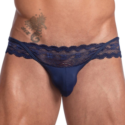 A person wearing the Secret Male Sissy Garter Bikini in navy blue lace, adorned with a scorpion tattoo on their hip, showcases a flattering fit.