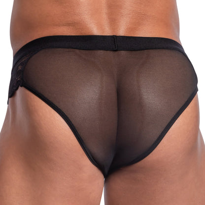 The image features a model wearing the Secret Male Steel Ring Sheer Bikini by Secret Male, viewed from behind. The black, sheer mesh fabric elegantly accentuates the garments design and smooth texture, subtly enhancing its allure.