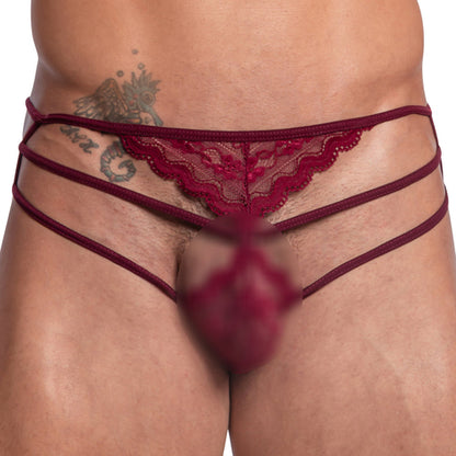 A model wears the Secret Male 2 in 1 Lacy Bikini, featuring luxurious lace and a flattering fit. The red strappy underwear enhances the design while maintaining modesty. A tattoo on the upper hip adds a unique touch to this elegant Secret Male ensemble.