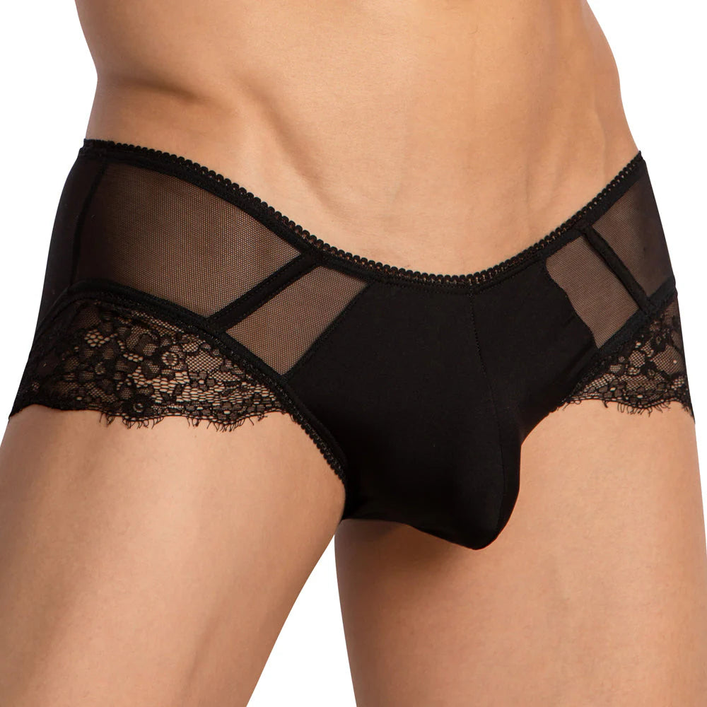 A person is wearing the Secret Male Low Rise Floral Bikini by Secret Male, featuring elegant black lace and sheer panels for added allure.
