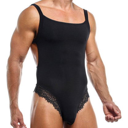 A man dons the Secret Male Honeymoon Body Suit, a black sleeveless piece with lace accents on the legs. The form-fitting design highlights his muscular build and seductive style against a plain white background, emphasizing the attire by Secret Male.