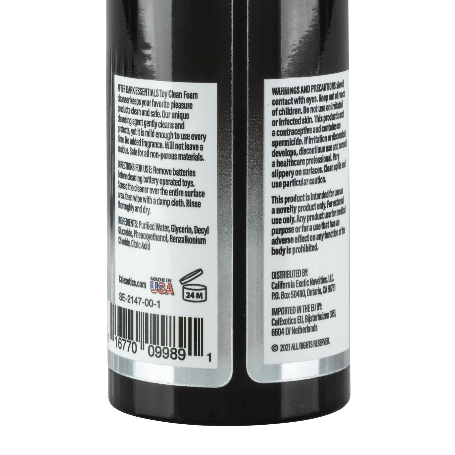 A close-up of the After Dark Essentials Foam Toy Clean by California Exotic Novelties shows warnings, precautions, ingredients, and usage instructions. Highlights its water-based formula, distribution info, barcode, Made in USA label, 24M shelf life symbol, ensuring safe foaming toy cleaning.