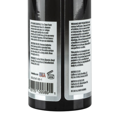 A close-up of the After Dark Essentials Foam Toy Clean by California Exotic Novelties shows warnings, precautions, ingredients, and usage instructions. Highlights its water-based formula, distribution info, barcode, Made in USA label, 24M shelf life symbol, ensuring safe foaming toy cleaning.