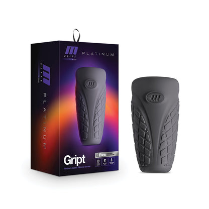 The Blush M Elite Platinum Gript Silicone Stroker by Blush Novelties is a matte black silicone personal massager for men, featuring a textured surface and flexible design. It is packaged in a stylish box with dark gradient accents, highlighting the branding and product details.