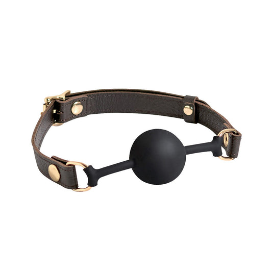 The Spartacus Silicone Ball Gag features a 43mm black silicone ball and a brown leather strap with gold accent hardware.