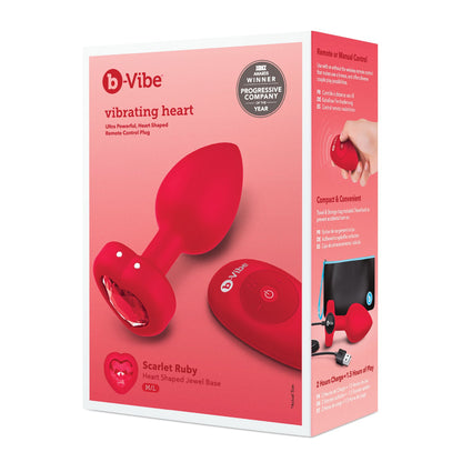 The image displays the b-Vibe Vibrating Heart Plug by b-vibe, a red, remote-controlled plug with a heart-shaped jewel base and compact design. Its packaging highlights award recognition, making it the perfect addition to your booty bling collection for anal adventures.
