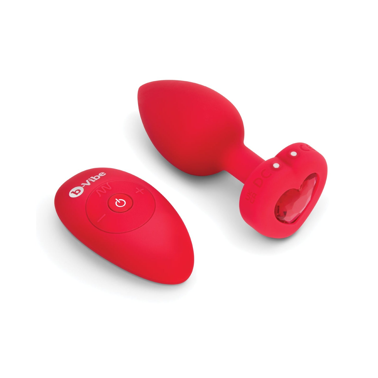 The b-Vibe Vibrating Heart Plug features a red, heart-shaped remote that adds chic booty bling. Its sleek design with power and function buttons pairs perfectly with the matching red silicone plug, all elegantly presented against a white background for your anal adventures by b-vibe.