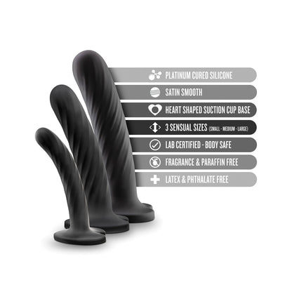 The Blush Temptasia Twist Kit by Blush Novelties offers three black silicone dildos in small, medium, and large sizes. Made with platinum-cured silicone and a satin-smooth texture, they feature heart-shaped suction cups for stability and are body-safe, fragrance-free, and latex-free.