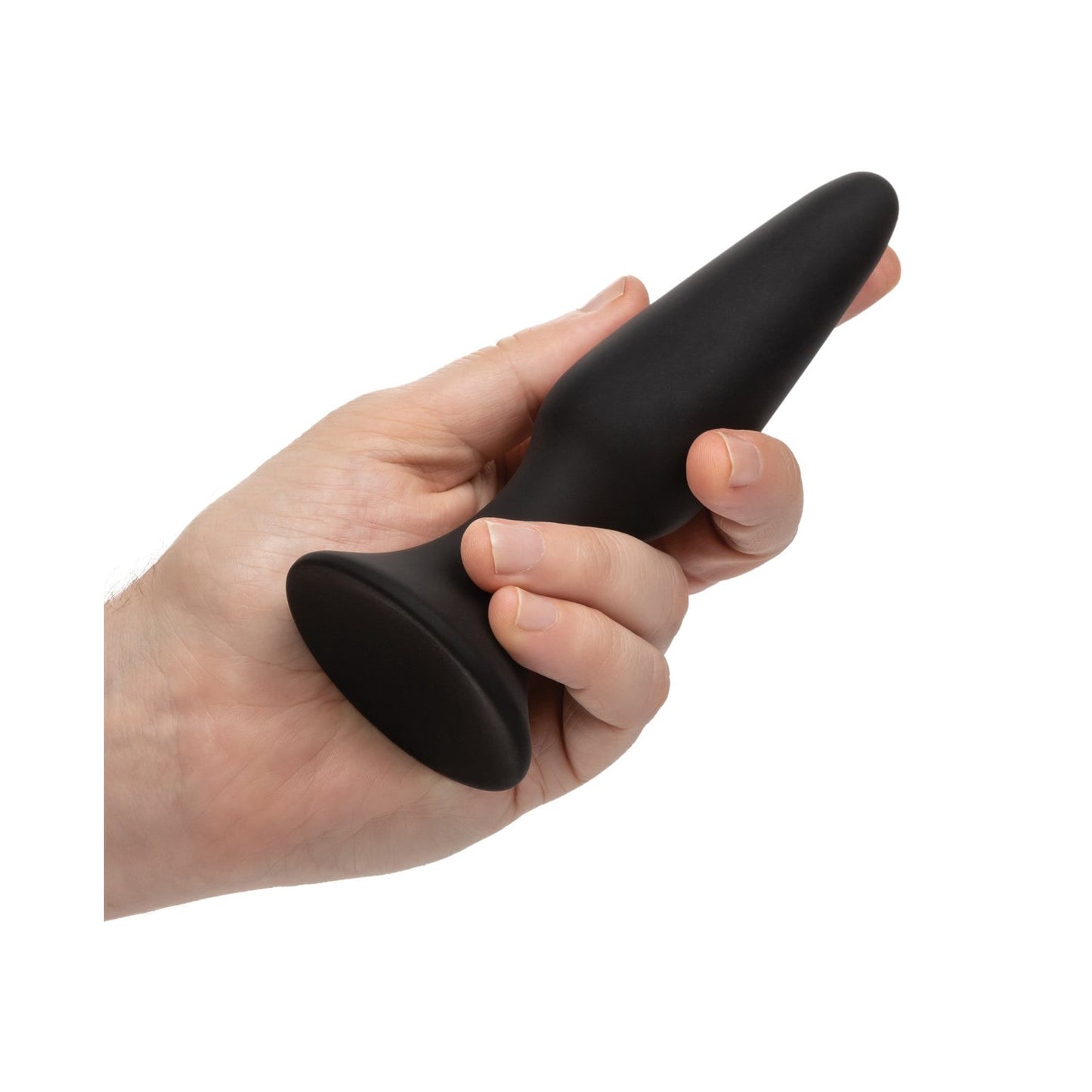 A hand holds a black anal plug made of body-safe silicone with a flared base, reminiscent of the quality found in the COLT Silicone Anal Trainer Kit by California Exotic Novelties. The background is plain white.