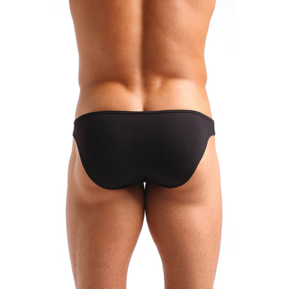 Rear view of a person wearing Cocksox Enhancing Pouch Brief Black Outback, crafted with Supplex® fabric and featuring a design reminiscent of the Cocksox® CX01 style.