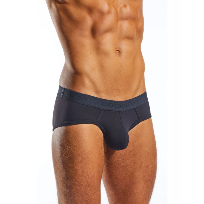 A person poses in the stylish Cocksox Contour Pouch Sports Black Brief, designed with a visible waistband and contour pouch, against a white background, highlighting the midsection and upper thighs.