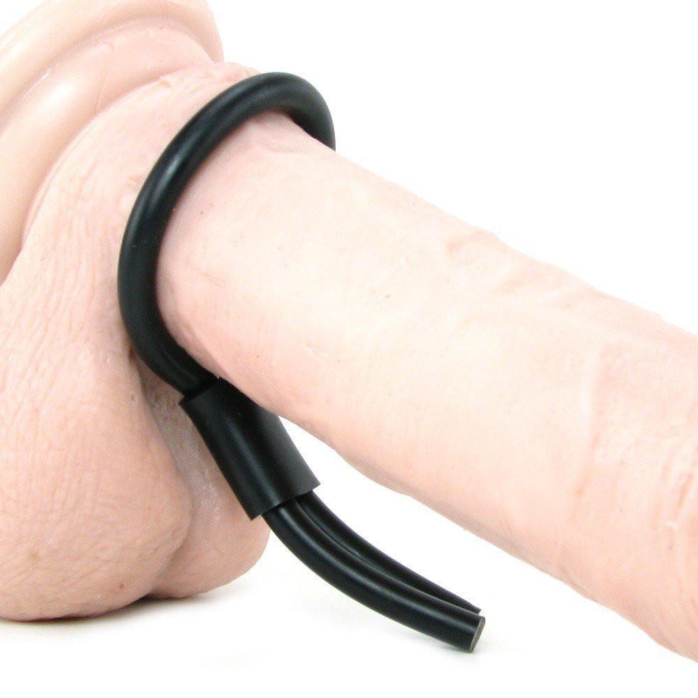 A close-up of the California Exotic Silicone Stud Lasso, a beige silicone cock ring by California Exotic Novelties with a black adjustable ring. Designed for comfort and enhanced stamina, it wraps securely around the cylindrical shape.