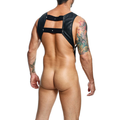 A tattooed person wearing the Dngeon Croptop Harness Cockring reveals intricate tattoos on their bare back while standing against a plain white background.