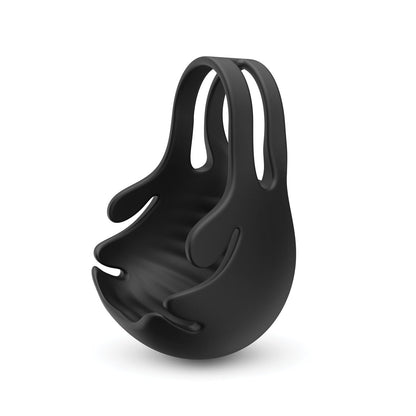 The Dorcel Fun Bag Testicle Vibrator features a black, abstract design with a smooth, droplet-like flow. Its curved form integrates comfort and aesthetics, reminiscent of expertly crafted ball pouches by Dorcel for a unique, modern look.