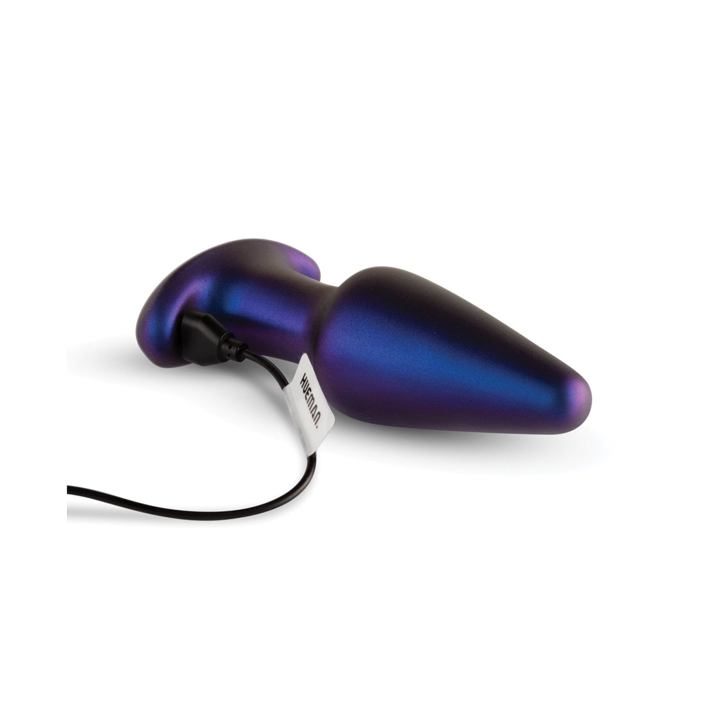 The Hueman Meteoroid Rimming Anal Plug, metallic and cone-shaped with a dark iridescent hue, features a bulbous end tapering to a point. Connected to a cord with a tag, it promises thrilling rimming sensations while elegantly resting on a white background.
