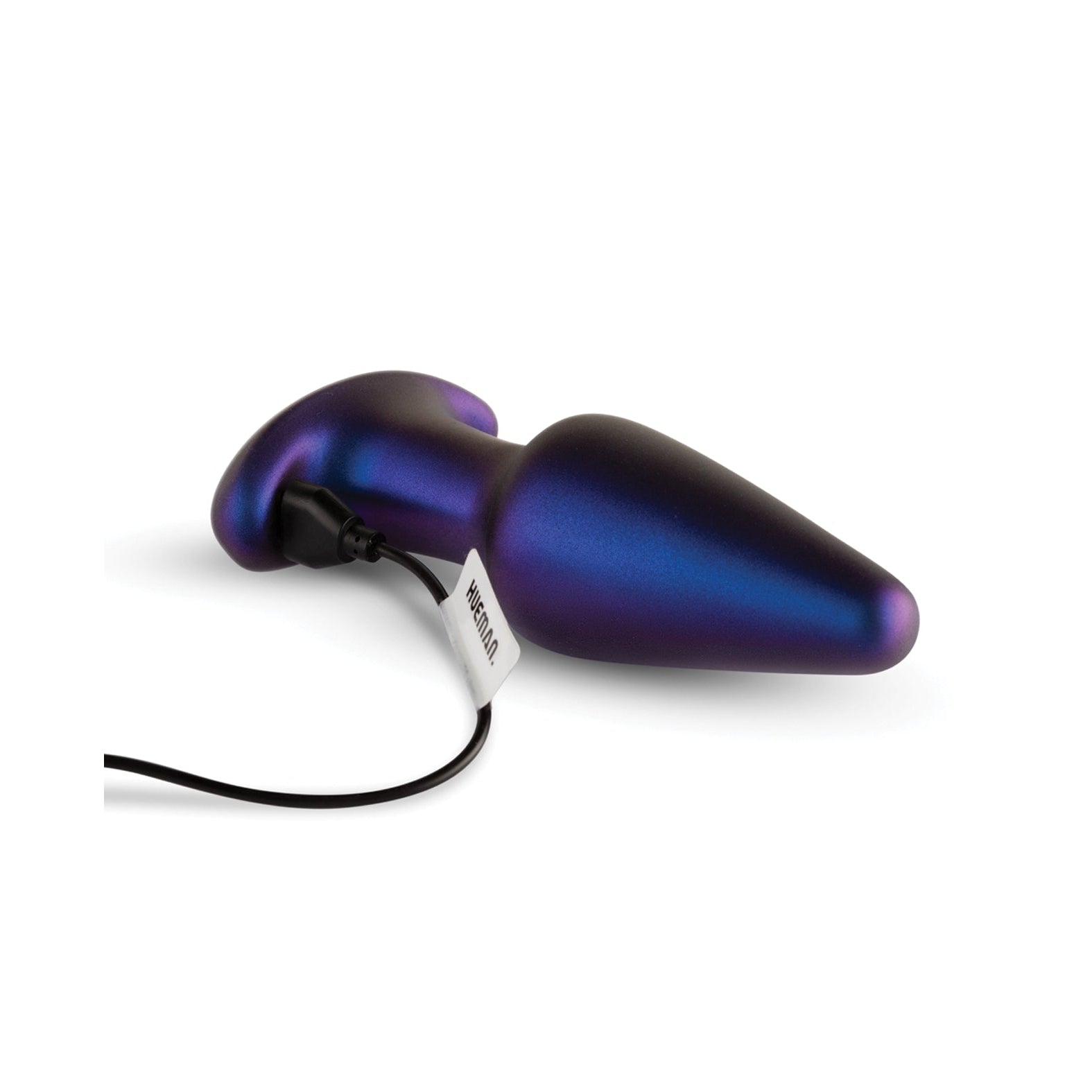 The Hueman Meteoroid Rimming Anal Plug, metallic and cone-shaped with a dark iridescent hue, features a bulbous end tapering to a point. Connected to a cord with a tag, it promises thrilling rimming sensations while elegantly resting on a white background.