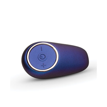 The Hueman Meteoroid Rimming Anal Plug, shaped like a sleek meteoroid, has a light metallic finish. Its central control button features power and volume symbols. Displayed on a white surface, it showcases its sophisticated design.