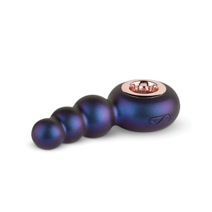 The Hueman Outer Space Vibrating Beaded Anal Plug is a dark blue metallic device with gold accents and round, graduated spheres. It includes a side button for prostate stimulation and is elegantly displayed against a white background.