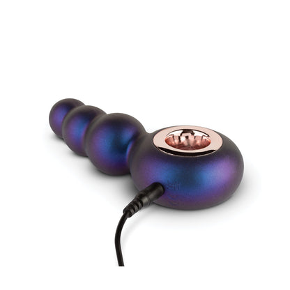 The Hueman Outer Space Vibrating Beaded Anal Plug by Hueman features a metallic, gradient design with spherical beads and a rose gold accent. Designed for prostate stimulation, it includes a charging cable. Set against a pristine white background, the sleek design is highlighted.