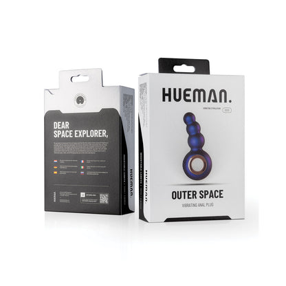 The image shows the packaging for the Hueman Outer Space Vibrating Beaded Anal Plug, designed for prostate stimulation. It features a photo of the blue, multi-beaded device on a predominantly white box with black text, emphasizing its remote control feature for convenience.