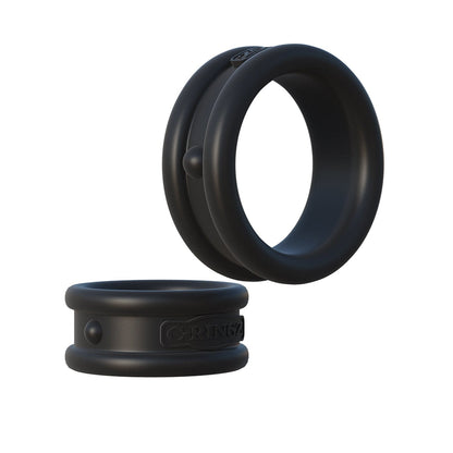 Image of two black Fantasy C-Ringz Max Width Silicone Cock Rings by Pipedream Products, featuring a smooth finish. One upright and the other flat, they are crafted from body-safe silicone with a raised button and embossed logo, designed to promote harder erections.