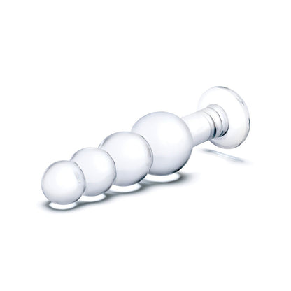 The Glas 7.25 Glass Beaded Butt Plug by Glas features a transparent, hand-blown design with a round base and four graduated bulbs for enhanced anal pleasure, set against a pristine white background.