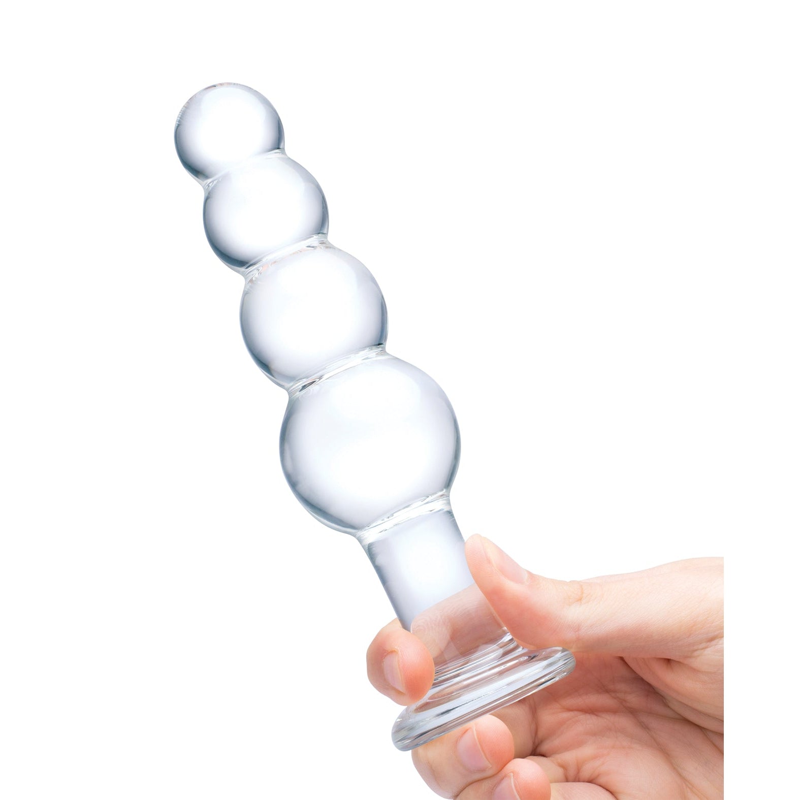 A hand holds the Glas 7.25 Glass Beaded Butt Plug, featuring four rounded segments for personal use. The transparent design of this Glas toy stands out against a white background, highlighting its clarity and shape.