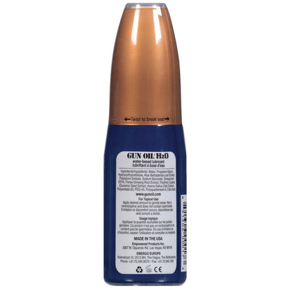 A vertically positioned blue and copper Gun Oil - H2O bottle, a long-lasting water-based lube with aloe vera. The label provides usage instructions, ingredients, and contact info. The cap instructs twist to break seal.