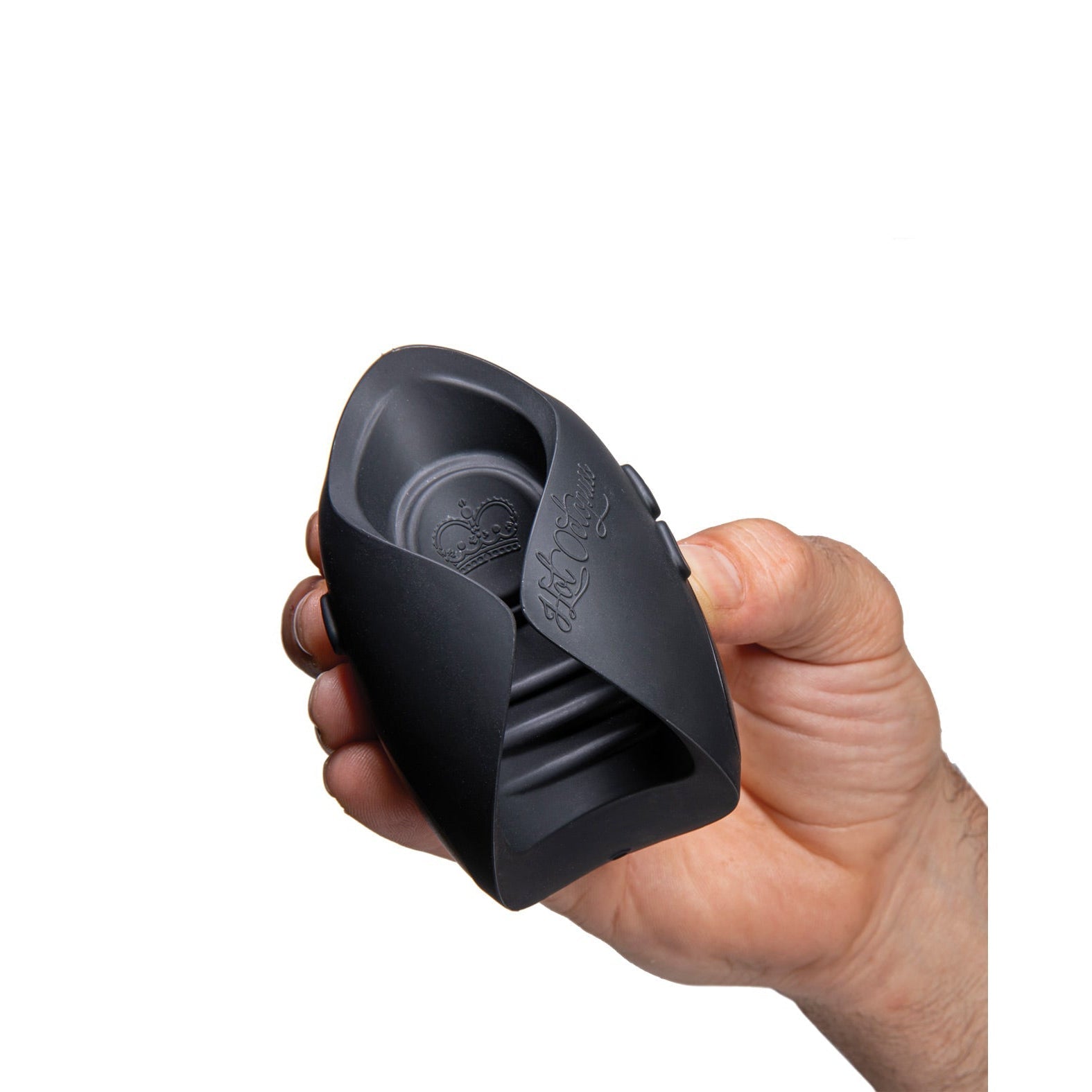 A hand holds a black silicone tea bag squeezer with a unique leaf-shaped design, reminiscent of sleek contours seen in Hot Octopuss products like the Pulse Solo Essential. The squeezer has grooves for grip and an imprinted logo inside against a plain white background.