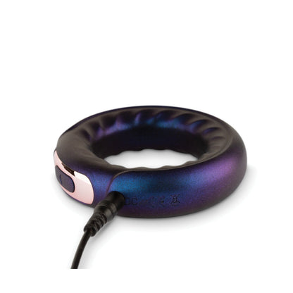 The Hueman Saturn Vibrating Cock & Ball Ring by Hueman is a circular, metallic dark purple device with a glossy finish, designed for intergalactic fun. It features an inner indentation, an attached charging cable, and 10 vibration modes for an exhilarating experience.