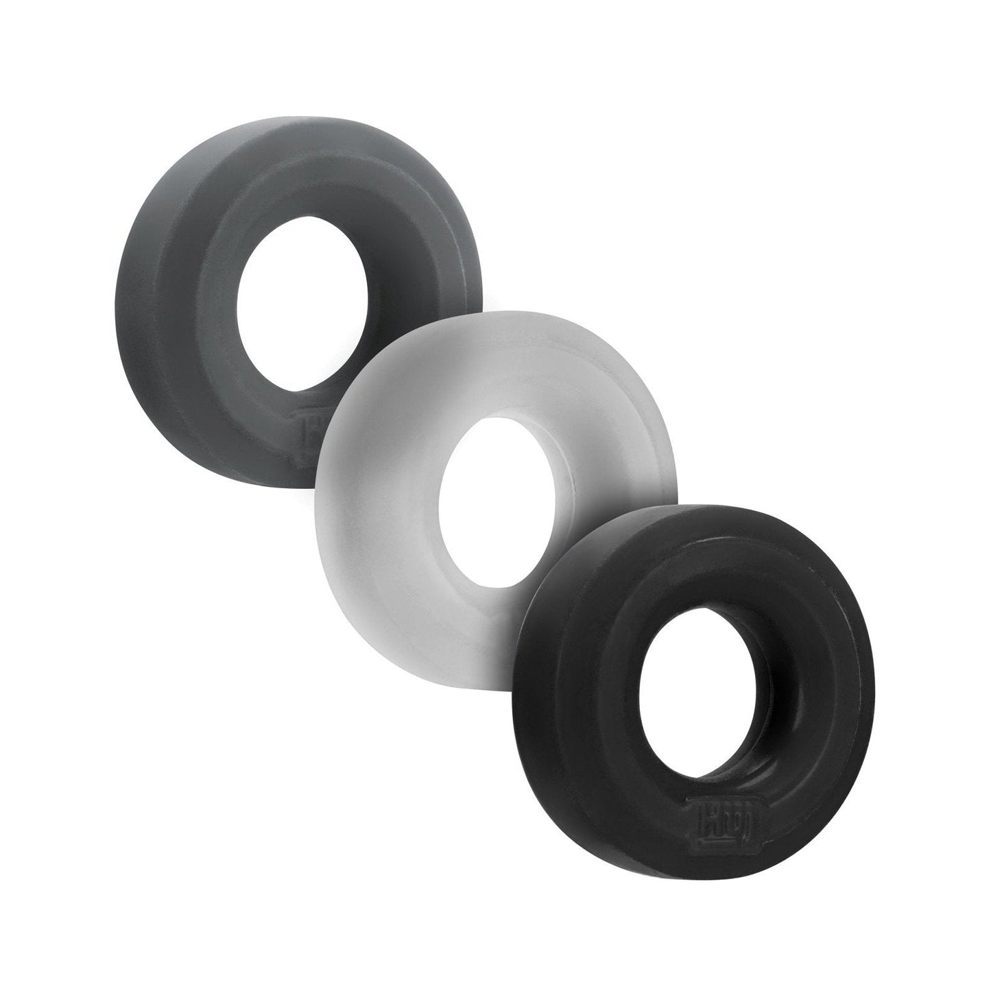 The Hunky Junk C Ring Multi Pack includes three stackable workout rings in black, light gray, and dark gray. Made from Plus+silicone for a smooth texture, each ring has a central hole for grip strength and resistance exercises. Ideal for enhancing your fitness routine.