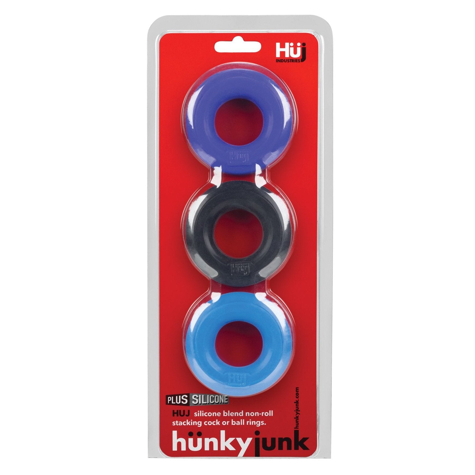 The Hunky Junk C Ring Multi Pack displays three assorted cock rings in purple, black, and blue against a vibrant red backdrop. Branding and product details are prominently featured on the packaging.