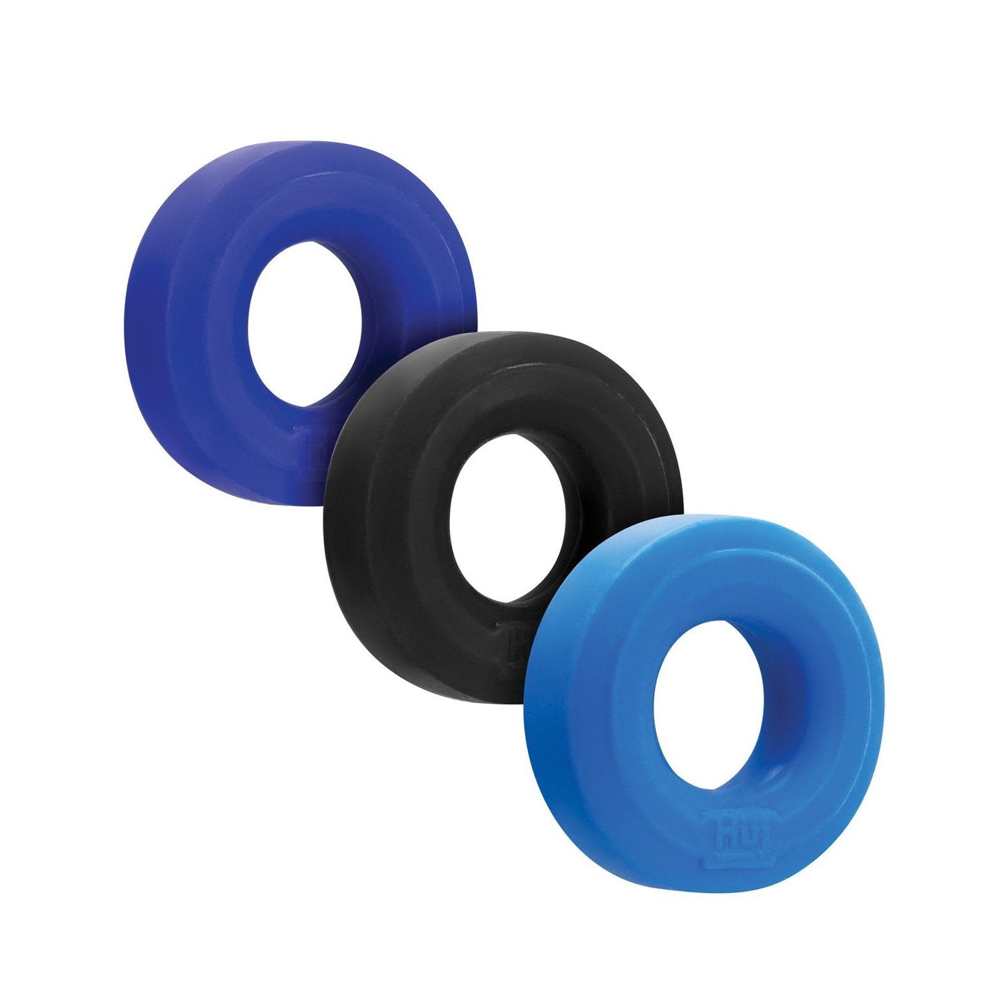 The Hunky Junk C Ring Multi Pack features three rubber ring toys crafted from Plus+silicone, available in blue, black, and light blue. Each has a hollow center and is arranged diagonally from top left to bottom right.