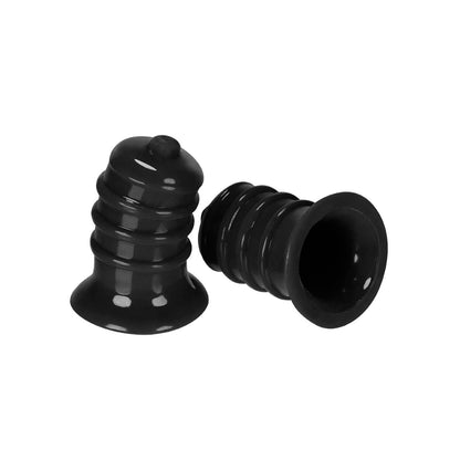 Two Hunky Junk Elong Nipsuckers, black and bell-shaped with ridged surfaces, are showcased. One stands upright and the other lies on its side, displaying a glossy finish for enhanced nipple pleasure.