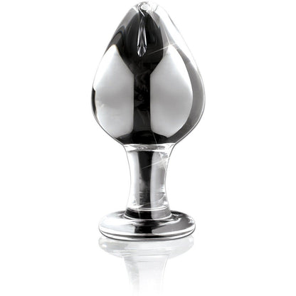 The Icicles No. 25 Hand Blown Glass Butt Plug from Adams Toy Box features a smooth, bulbous shape. It sits upright on a reflective surface, ideal for body-safe temperature play.