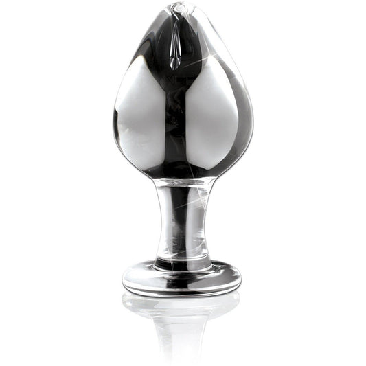 The Icicles No. 25 Hand Blown Glass Butt Plug from Adams Toy Box features a smooth, bulbous shape. It sits upright on a reflective surface, ideal for body-safe temperature play.
