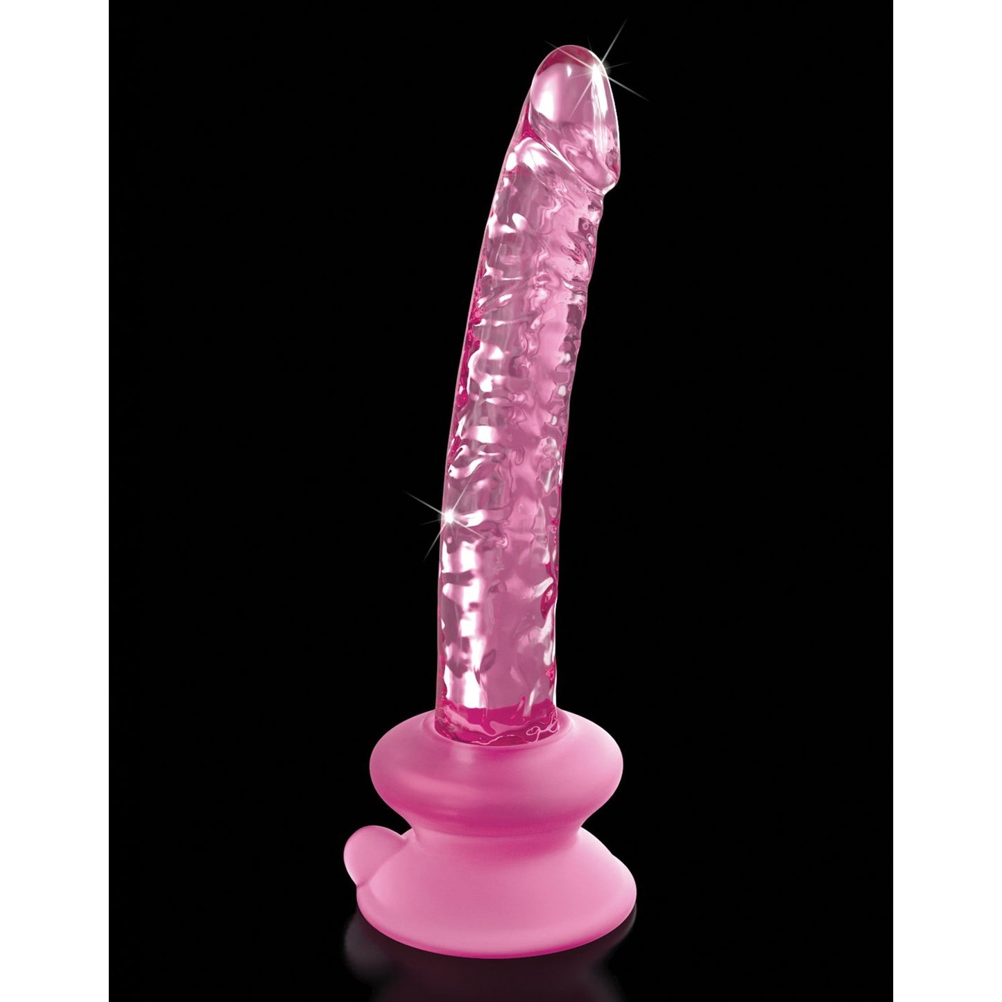 The Icicles No. 86 Hand Blown Glass Massager by Icicles is a ribbed, penis-shaped pink translucent massager with a suction cup base for stability, standing upright against a black background.