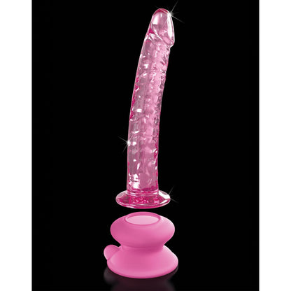 The Icicles No. 86 Hand Blown Glass Massager has a curved, textured, pink shape and stands upright against a black background, securely attached to its sturdy suction cup base.
