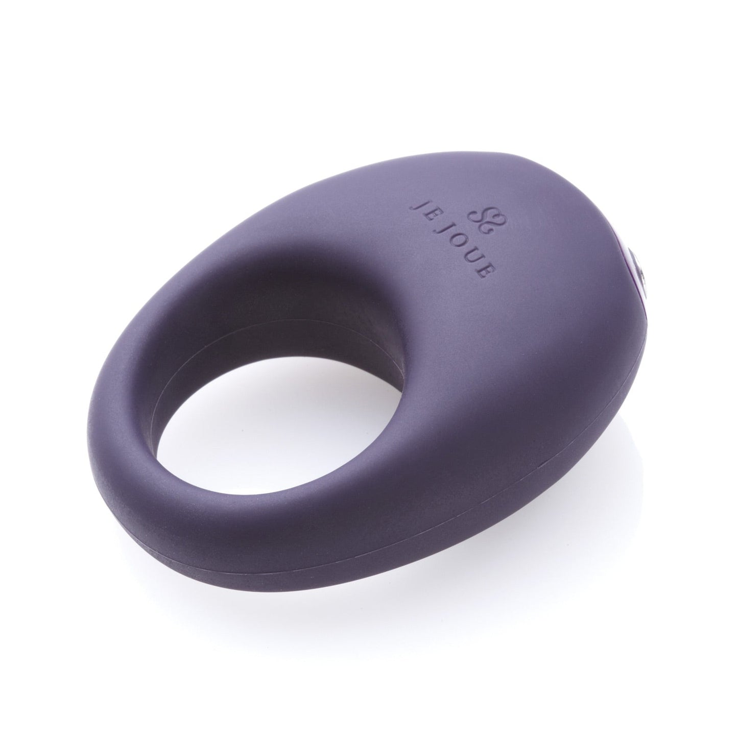 A black, smooth-textured ring with Je Joue engraved rests on a white background. The Je Joue Mio Cock Ring features discreet vibrating functions for added pleasure.