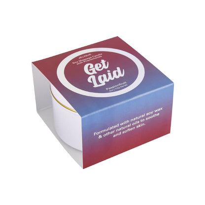 The Jelique Massage Candle - 4 oz Get Laid Passion Fruit comes in a red-to-blue gradient box labeled Get Laid. Made with vegan-friendly soy wax and infused oils, this scented massage oil candle soothes and softens skin for a perfect relaxing evening.
