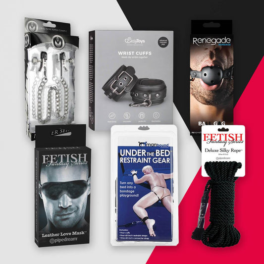 The Kink! collection by Adams Toy Box features adult bondage accessories, such as wrist cuffs, a ball gag, a leather love mask, an under-the-bed restraint system, chain nipple clamps, and a silky rope—all showcased elegantly against a split black and red background.
